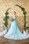 Bride in a beautiful turquoise dress in anticipation of wedding. Blonde in lace dress sea green with a bouquet . Happy bride