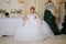 Bride in a beautiful white dress in a nice room before Christmas