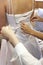 Bride being laced up into wedding dress