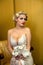 Bride blond with a bouquet sits on a chair