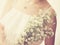 Bride with bouquet, closeup with retro filter effec