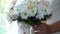 Bride with a bouquet of white daisies and delicate roses