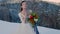 bride with a bouquet in winter