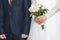 Bride and bridegroom on wedding ceremony. Bouquet of roses in hands of lady. Beautiful wedding dress and elegant costume