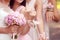 Bride and bridesmaid holding flowers