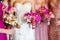 Bride with bridesmaids holding beautiful flower bouquet