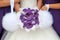 Bride and bridesmaids with purple orchid bouquet