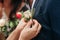 Bride dresses boutonniere to the groom