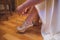 Bride dresses shoes before the wedding ceremony. Charges of the bride. Closeup detail of bride putting on high heeled