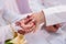 The bride is dressing the ring to the groom`s hand