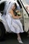 Bride exiting wedding car limo