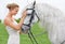 Bride, field and horse with face, happiness and smile for nature, connection and celebration. Woman, animal and uk
