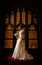 Bride in front of stained glass window