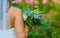 Bride in garden holds retro bouquet