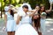 Bride and girls have fun while walking in the park