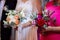 Bride and godmother holding wedding bouquets during wedding ceremony