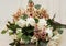 Bride golden crown with shining brilliants on rose bouquet