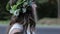 Bride with green crown on the head stay alone on the road and forest background. Slow Motion