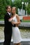 Bride and groom against urban fountain