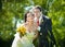 Bride and groom blowing dandelion