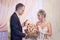 Bride and groom breaking traditional loaf