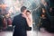 the bride and groom dance on stage in the banquet hall of the restaurant.