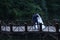 Bride and groom dancing on the bridge