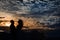 Bride and groom in the desert with sunset sky
