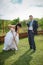 Bride and groom digs the soil on a kitchen garden.