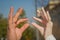 Bride and groom doing the infinity sign combining their wedding rings . men and woman married with hands and rings . the two rings