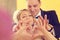 Bride and groom doing love sign with their hands