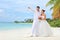 Bride and groom embracing on a beach