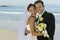 Bride And Groom Embracing On Beach