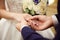 Bride and groom exchange rings at the wedding. Lovers put each other rings on the fingers