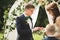 Bride and groom exchanging wedding rings. Stylish couple official ceremony