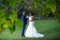 Bride and groom facing each other and holding hands