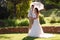 Bride and groom in garden wedding with parasol