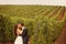 Bride and groom at a green cold rainy day vineyard