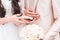 Bride and groom hands holding a small butterfly outdoors