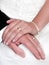 Bride and groom with hands over wedding dress