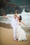 Bride and groom have fun by the sea. couple in love on a deserted beach