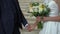 Bride and groom hold hands. Young woman in white wedding dress and man in suit.