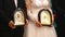 The bride and groom hold the icons in the Church during the wedding ceremony. Close up