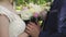 The bride and groom holding a bouquet and embracing, a wedding bouquet and hands closeup