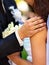 Bride and groom holding flower outdoor.