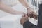 Bride and groom holding hands close-up