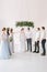 Bride and groom holding the hands of each other in the rain of rice after wedding ceremony