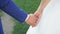 Bride and groom holding hands during walking