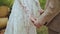 Bride and Groom Holding Hands at the wedding boho style ceremony. close-up holding hands, slow motion shot.