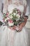 Bride and groom holding wedding bouquet
